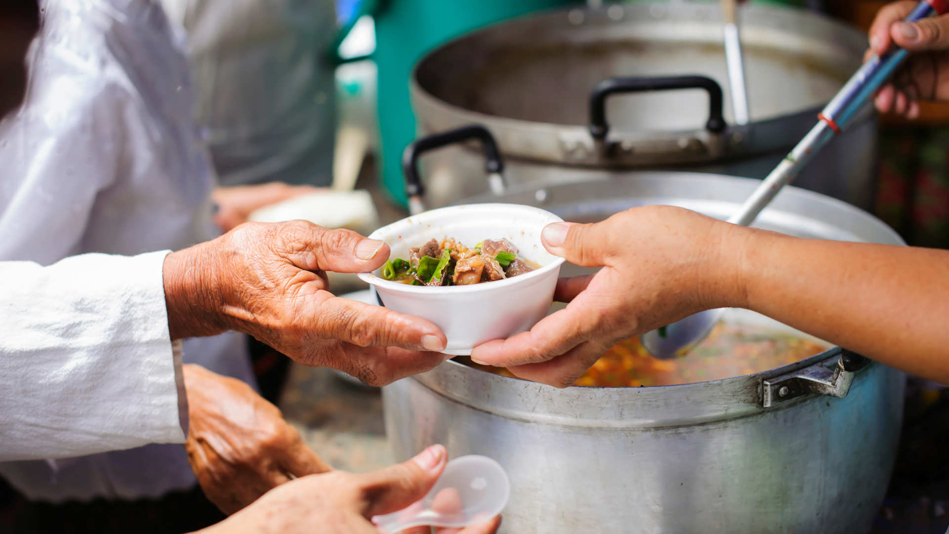 People giving away soup bowls