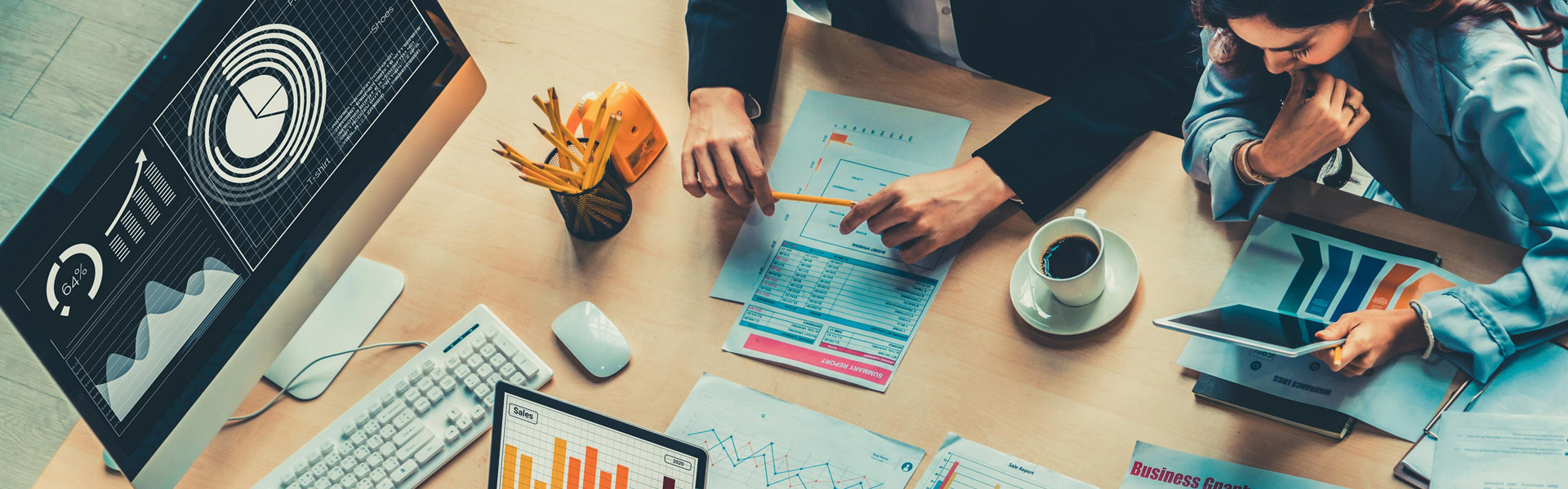 Business people sitting around the desk and looking at the statistics data.