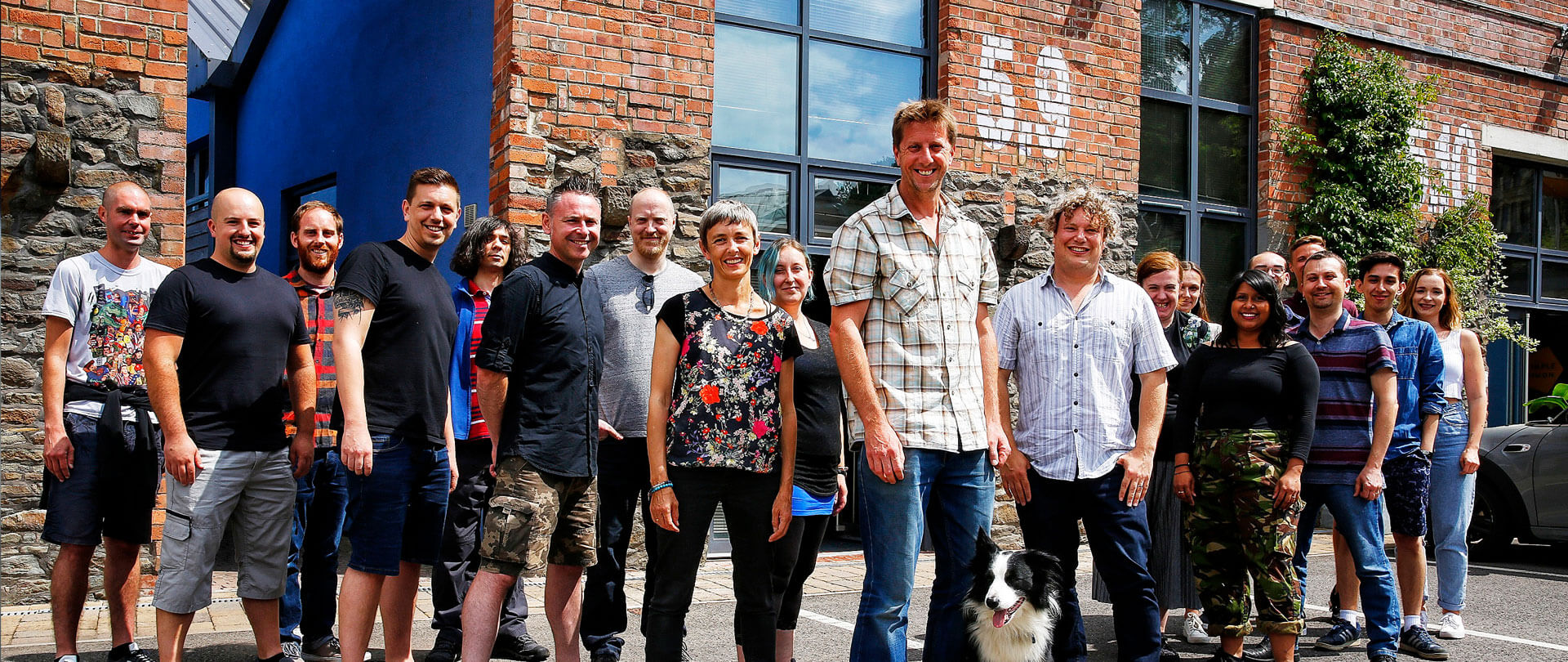 A group of people stood in front of a brick building