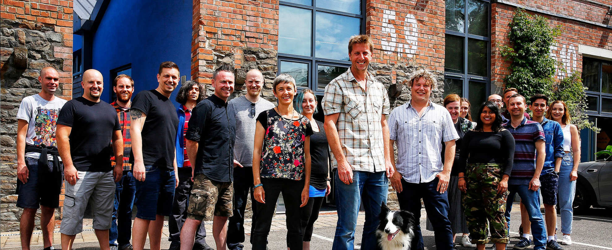 A group of people stood in front of a brick building
