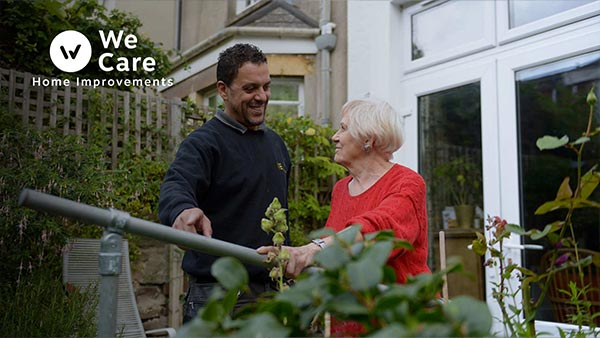 Man helping an elderly lady
