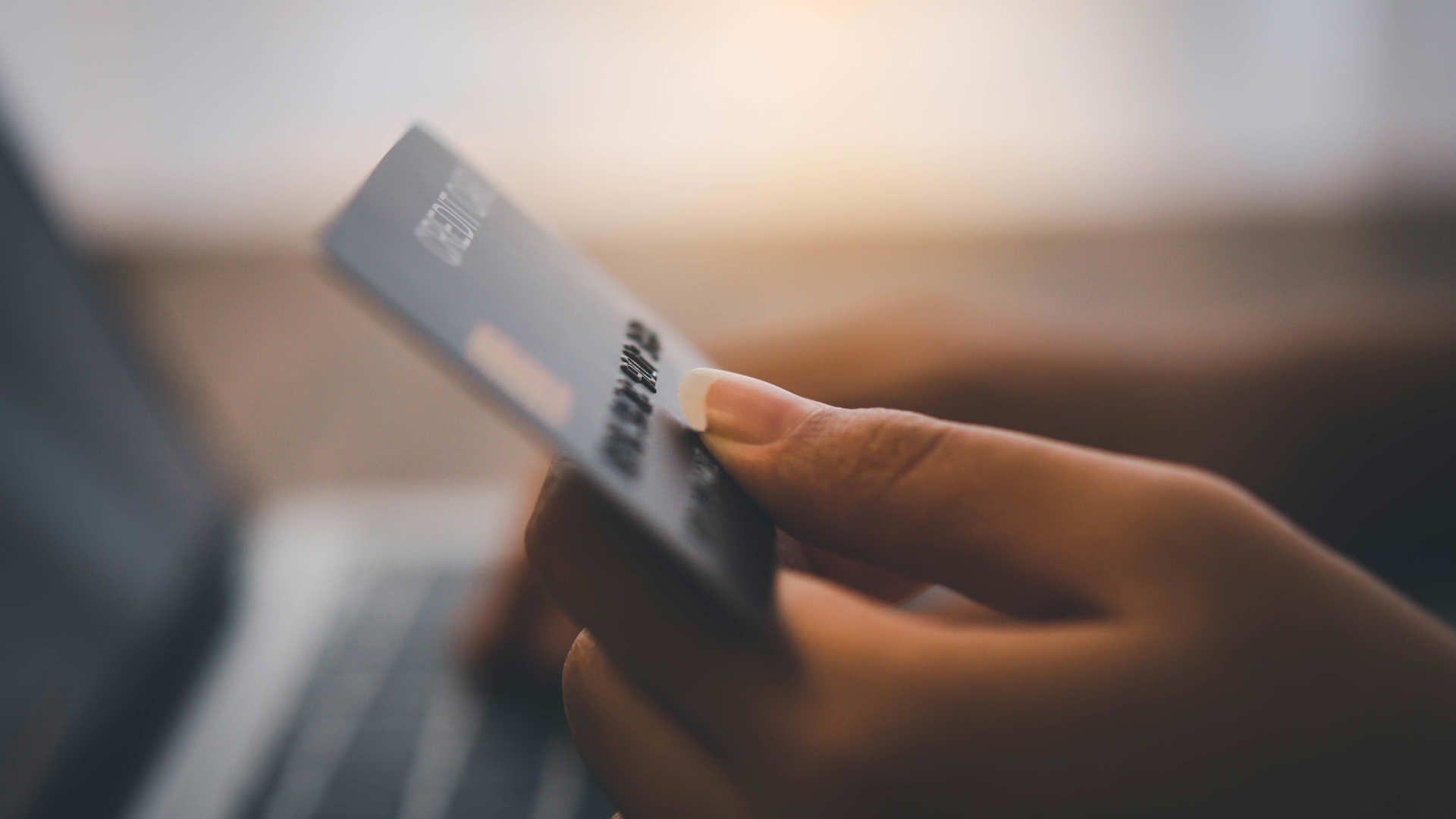 Women's hands holding a credit card and work on laptop Online payment for online shopping