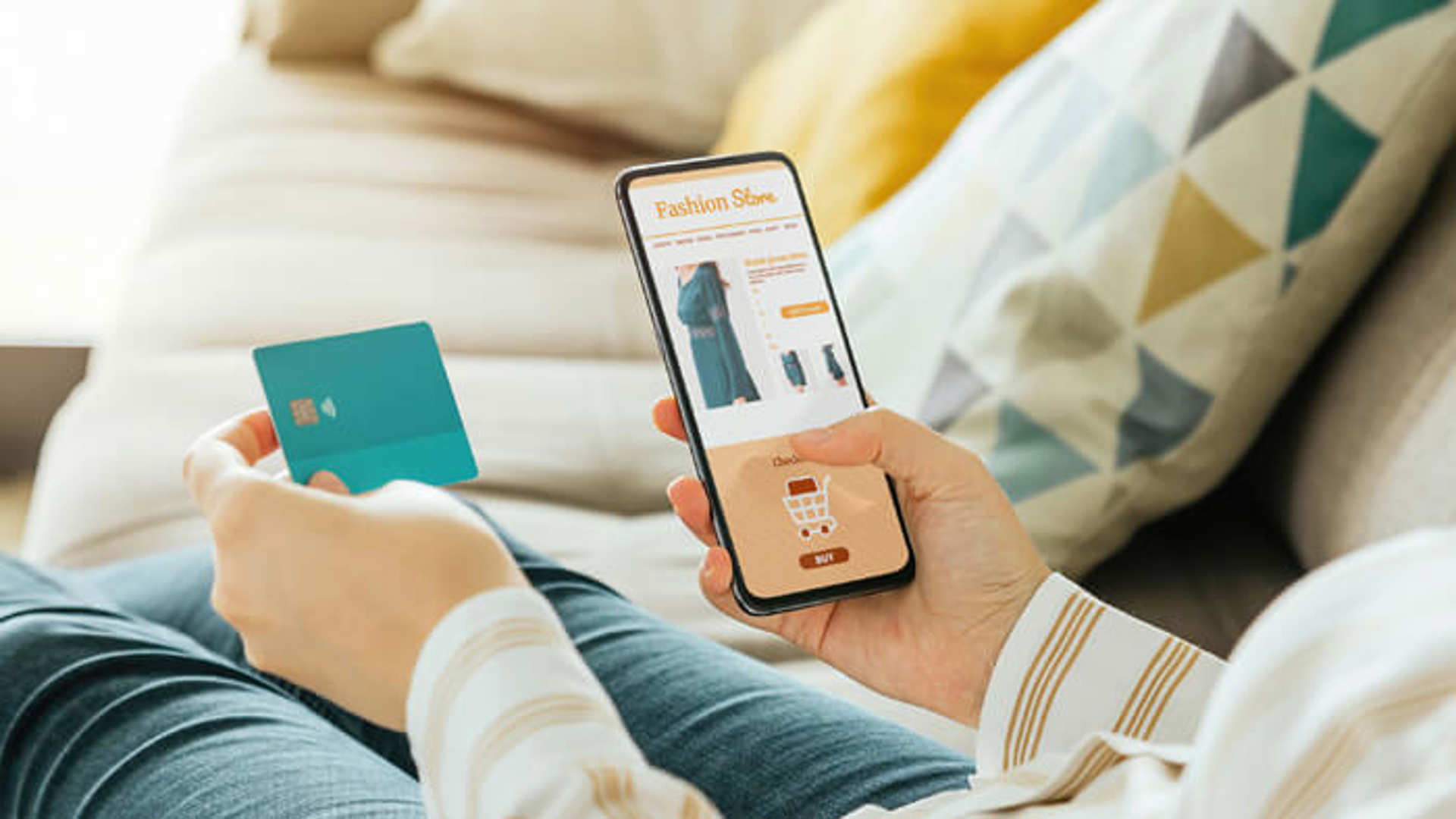 Woman shopping online via smartphone indoors, closeup, buying a dress.