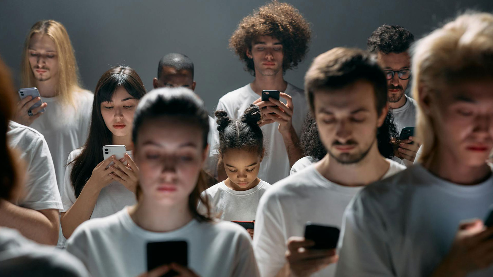 A diverse group of individuals focused on their smartphones, illustrating personalised digital experiences based on user profiles, preferences, and browsing habits.