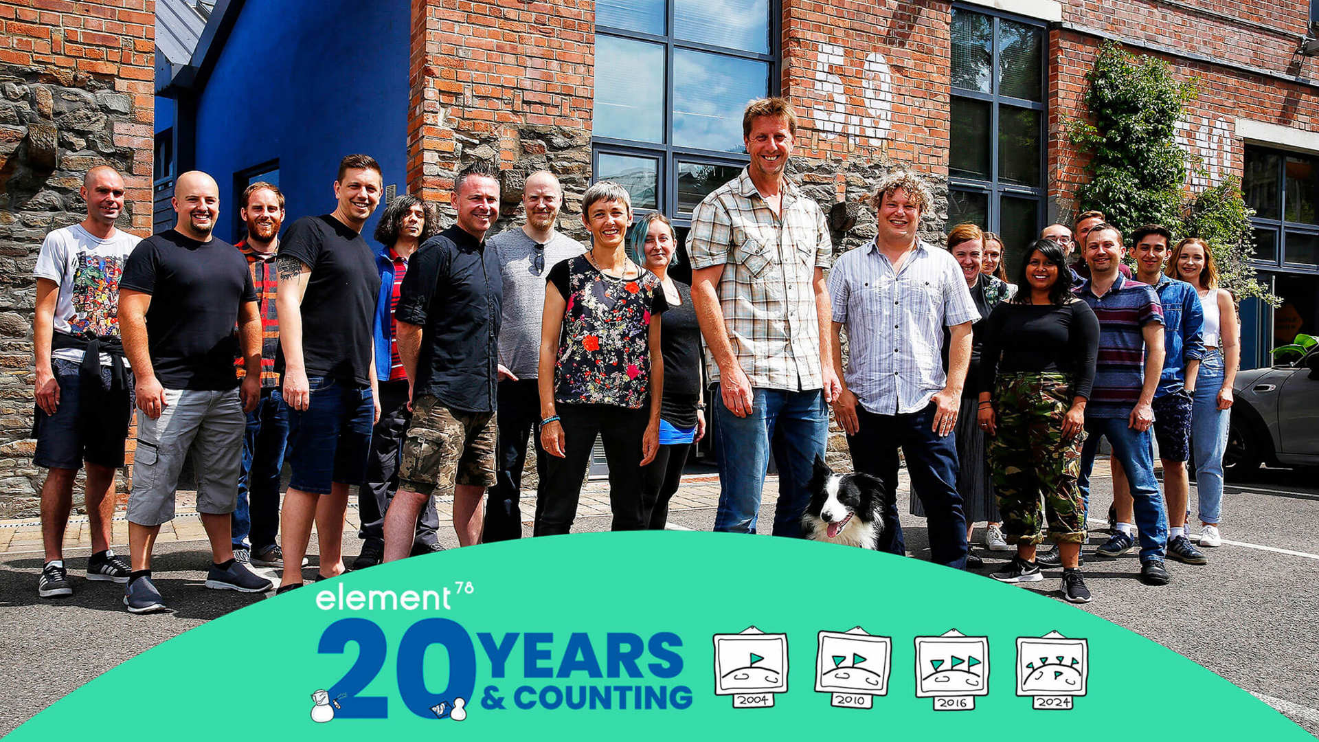 A group of people stood in front of a building with twenty years of Element 78 logo at the front.